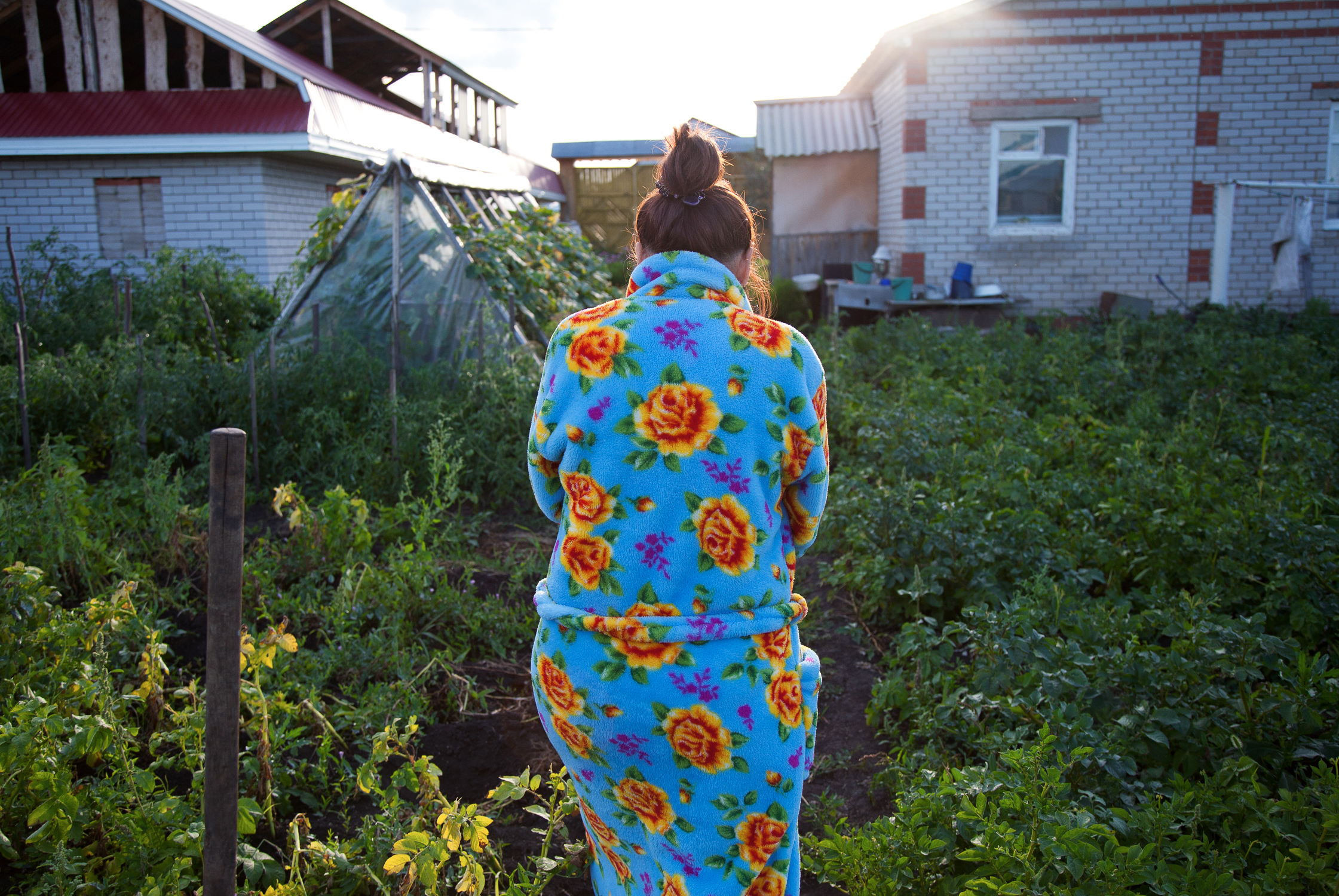 Zila Idrisova walks through her brother’s garden in the village of Aktanish.